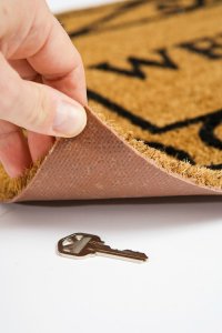 Common mistakes when hiding house keys - welcome mat - King Locksmiths